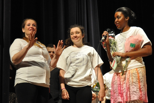 Senior dance students Hannah Geisz (center) and Erika Wilson (right) give flowers to The Studio Inc. owner Amanda Fedor at the end of the show. Fedor had just  paid tribute to each of them.