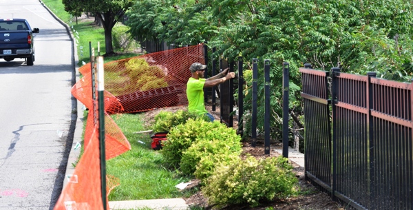 On Monday morning an employee of RV Wagner removes fence sections where a new walkway will be built between the Brentwood Pointe shopping center and the MetroLink station.