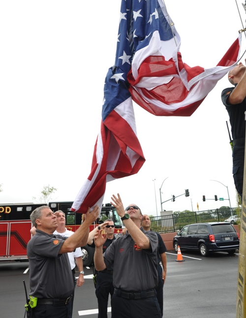 Brentwood firefighters raise the flag while the BHS band plays the National Anthem.