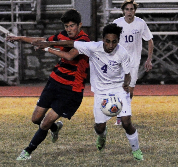 Cristian Sanchez (right) stays on the ball.