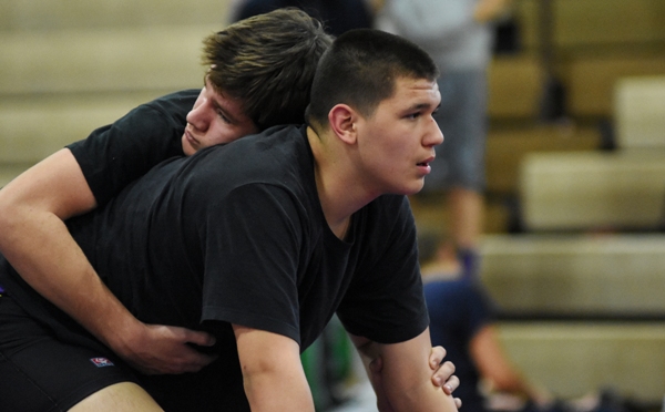 Donovan Obando (right) practices with teammate Sam Tilton before a meet on Feb. 2.